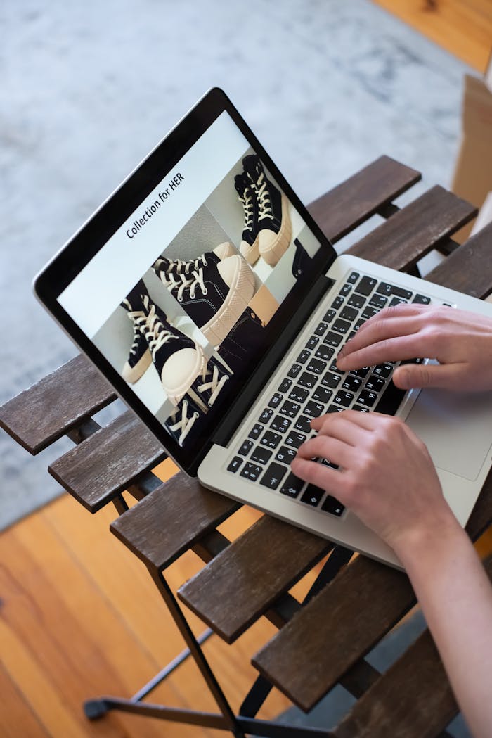 The Art of Drawing Readers In: Your attractive post title goes here Hands browsing sneakers on laptop, showcasing online store shopping experience.